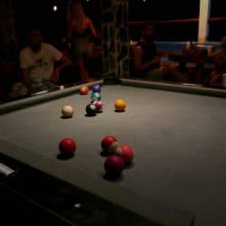 travelers playing pool at the bar in a hostel in el paredon