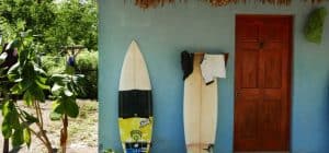 surfboards from travelers laying on a wall outside a private room at the driftwood surfer in a black sand beach called El Paredon Guatemala 