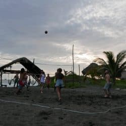 a volleyball match being played on the beach at El paredon